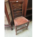 An early 20th century rail back hall chair