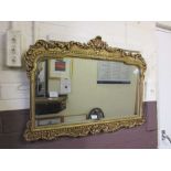 An early 20th century cast aluminium gilt framed bevel edged mirrorMultiple small chips to gilt on