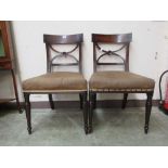 A pair of Regency mahogany and ebony banded dining chairs, the carved X back rail between reeded