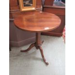 A 19th century circular walnut pedestal wine table