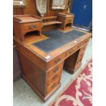 An Edwardian walnut twin pedestal desk, having raised top section with two trinket drawers and