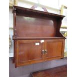 An Edwardian mahogany inlaid wall mounted cabinet having open storage above a pair of cupboard