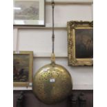 A brass Eastern style bed warming pan on metal handle