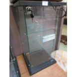 A glazed desktop display cabinet with key