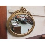 A gilt framed oval mirror