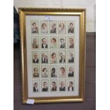 A framed and glazed cigarette card display of famous people