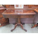 A 19th century rosewood card table, the fold over top supported on swivel action over turned