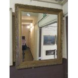An ornate gilt framed bevel glass mirror