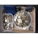 A cardboard box containing a quantity of coinage