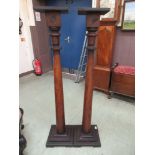 A pair of 19th century and later mahogany torcher stands