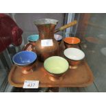 A hammered copper tray together with a hammered copper pouring jug, etc