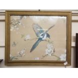 A framed and glazed oriental painting on silk of bird on flowering branch