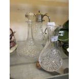 Three pressed glass items consisting of a ship's decanter, a wine decanter, and a water jug