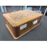 A carved wooden hinge top box