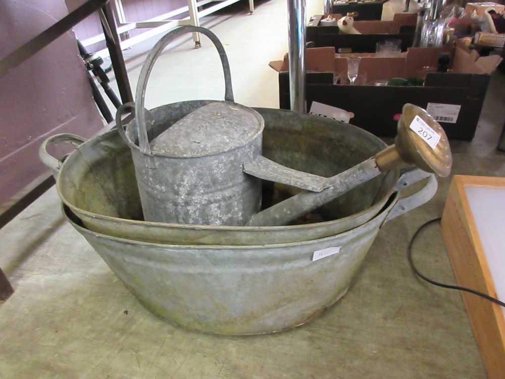 Two galvanised washtubs together with a galvanised watering can