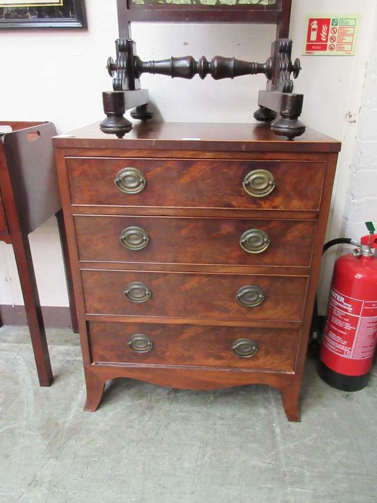 An early 20th century flame mahogany chest of four drawers on splay feet