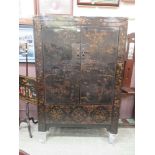 An early 20th century Chinese black lacquered cabinet, two doors enclosing single shelf