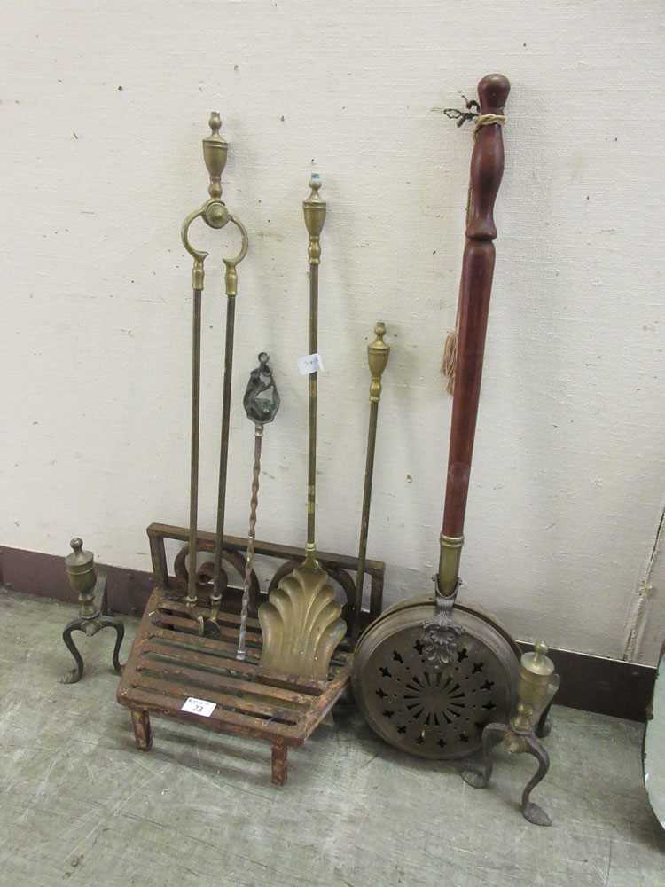 A cast iron fire grate along with a chestnut roaster, companion set, fire irons etc.
