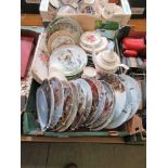 A tray containing collector's plates, decorative coffee pot, etc