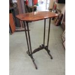 An early 19th century mahogany occasional table, the top on turned supports and carved stretcher