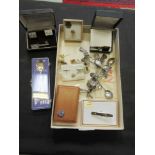 A box containing cuff links, white metal spoons, etc