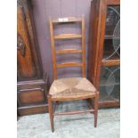 An early 20th century beech framed single chair with rush seat