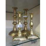 Two pairs of brass candlesticks