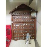 A selection of collector's spoons on wooden display rack