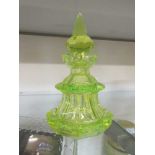 A green glass perfume bottle (A/F)Chips to rim and upper section. Stopper cracked. Chips to bottom