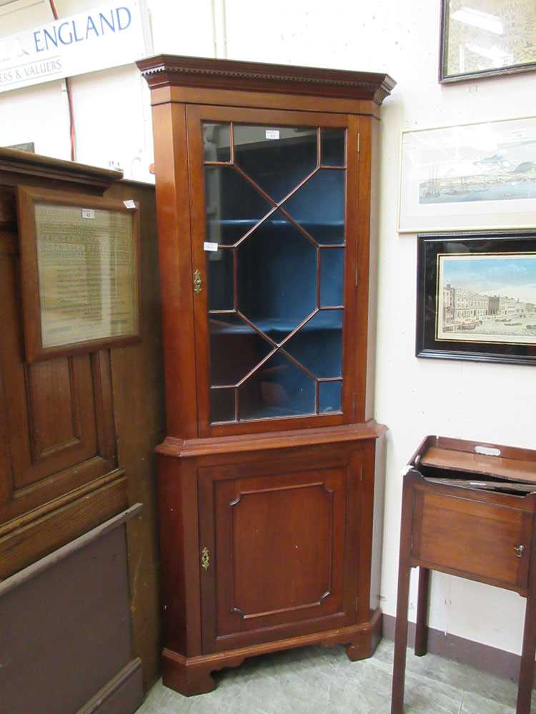 A reproduction mahogany floor standing corner cupboard with astragal galzed door to top