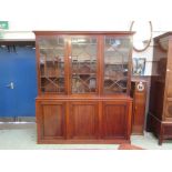 An early 20th century mahogany bookcase, three asternal glazed doors over three blind panel doors