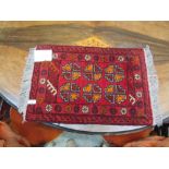 A small rectangular red ground rug