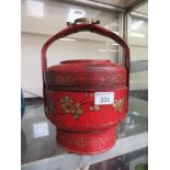 A red and gilt decorated oriental handled pot