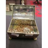 An old tin box containing a quantity of costume jewellery, mainly chains and bangles