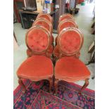 A set of six Victorian balloon back dining chairs upholstered in an orange button back fabric