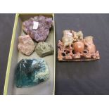 A collection of carved soapstone items, geodes, etc