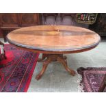 A Victorian walnut inlaid tilt top tea table