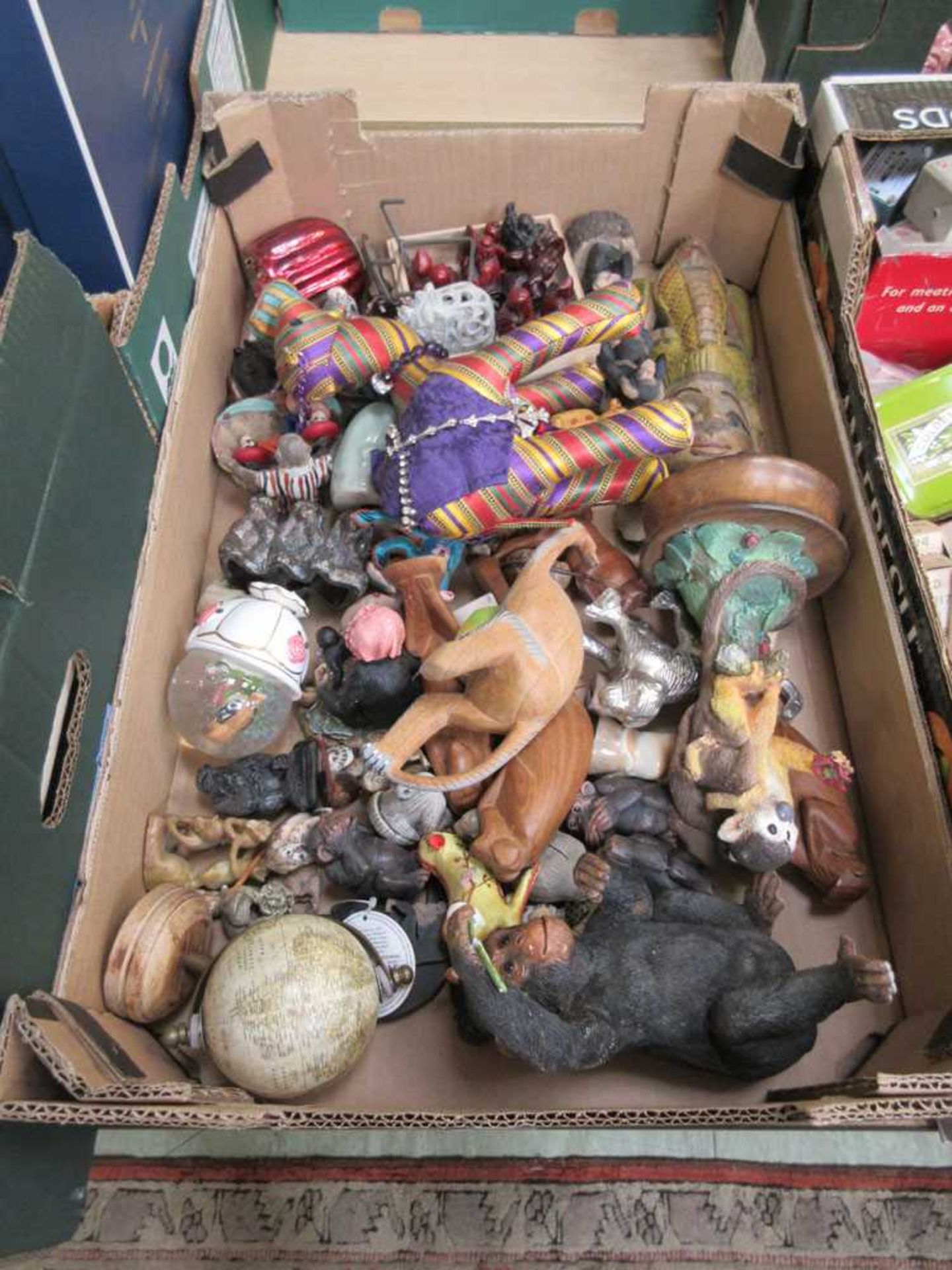 A tray containing miniature animals, resin figures, etc