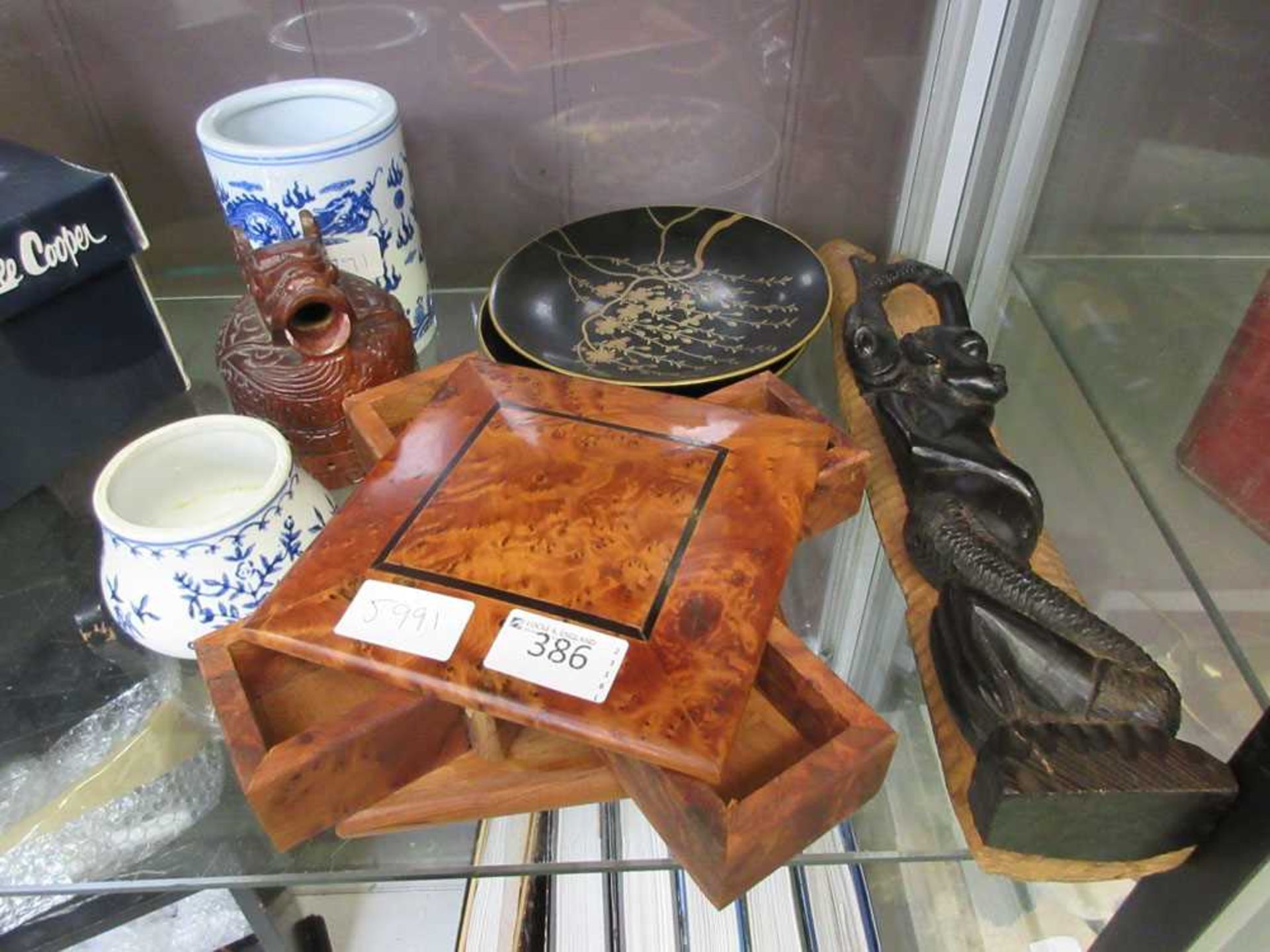 A selection of oriental and African items to include plates, pots, walnut puzzle box, etc
