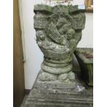 A composite stone medieval style garden pot