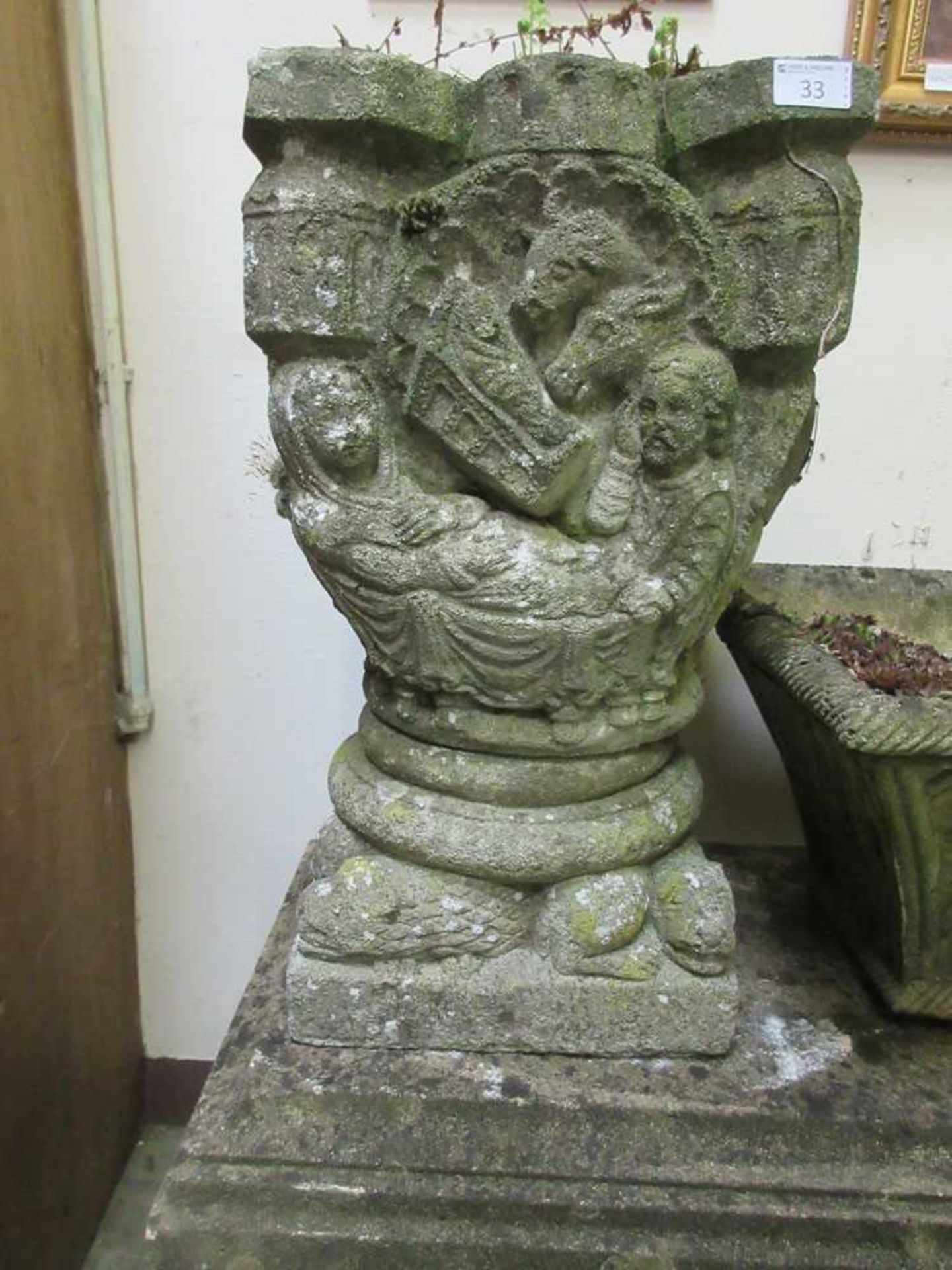 A composite stone medieval style garden pot