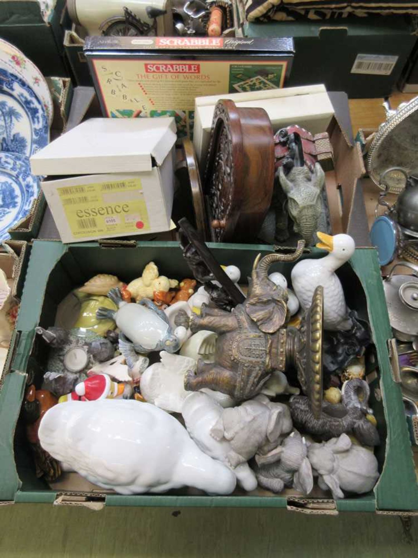 Two trays of assorted items to include figures of animals, Scrabble, wooden box, etc