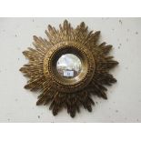 A reproduction sunburst convex mirror