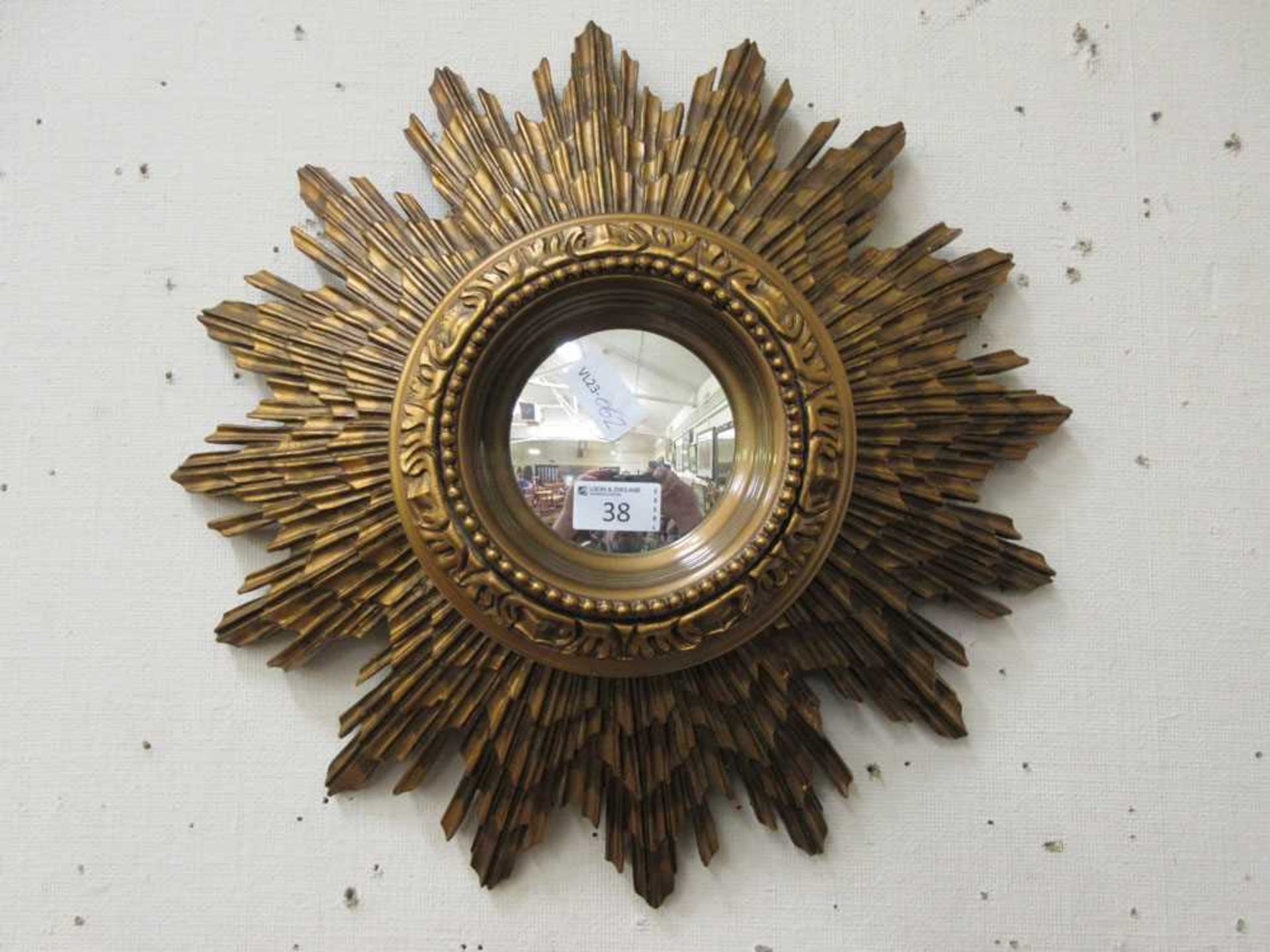 A reproduction sunburst convex mirror