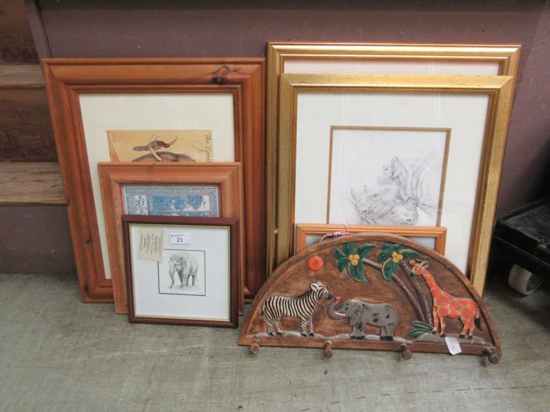 a collection of artworks, mainly depicting elephants to include prints, wall hooks etc.