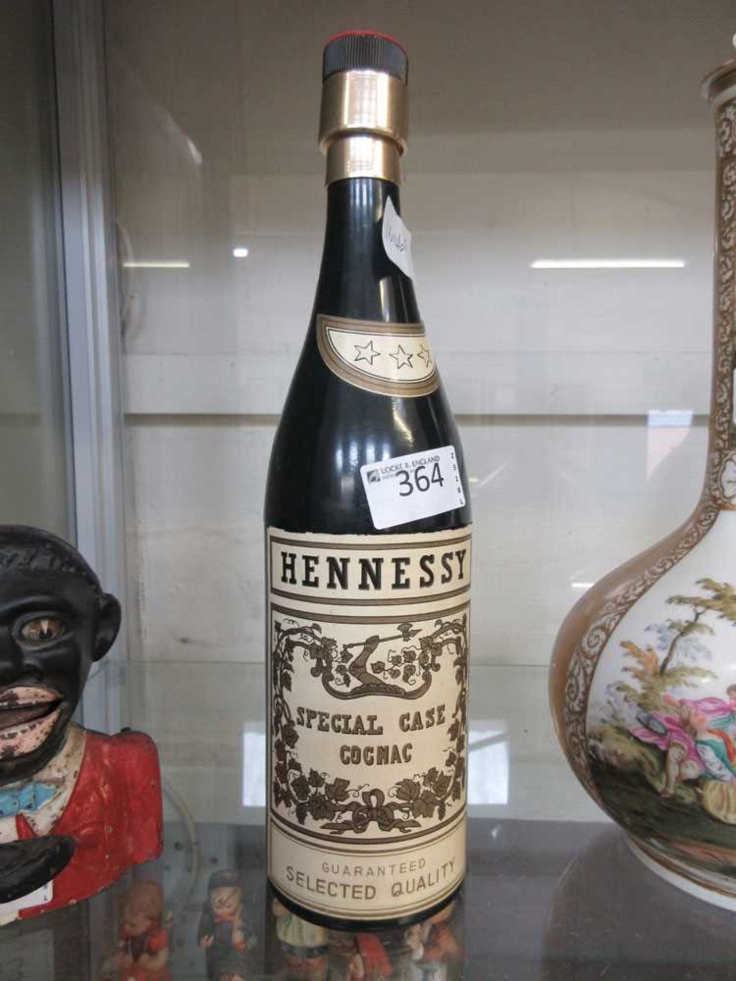 A mid-20th century cigarette dispenser in the form of a cognac bottle