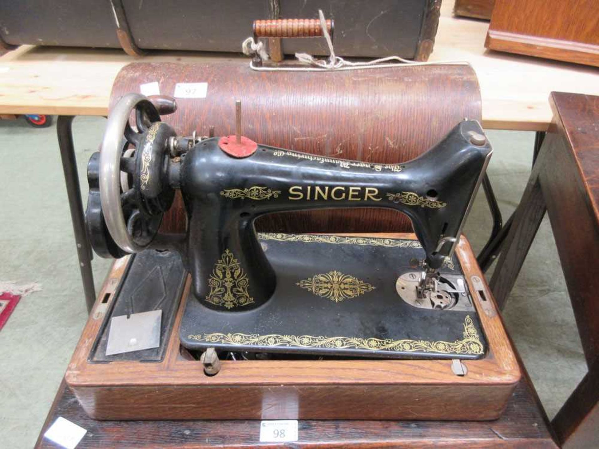 A dome cased Singer manual sewing machine