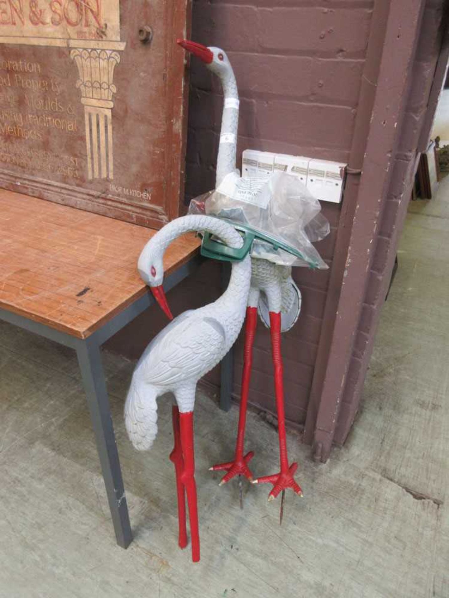 Two cast metal polychrome storks (A/F)