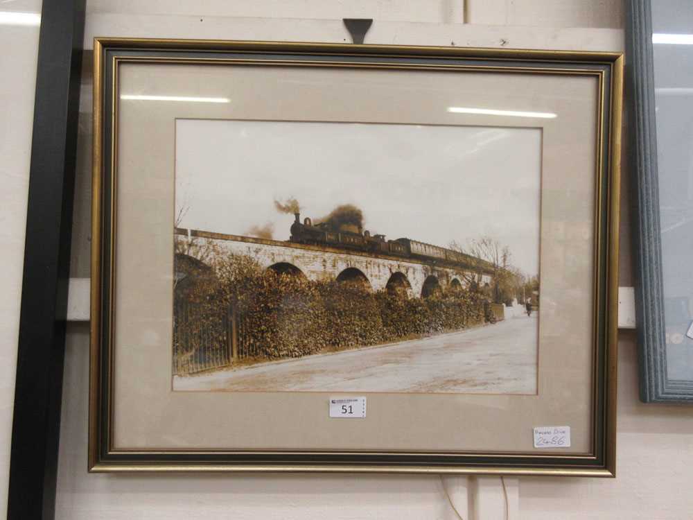 A framed and glazed photograph of steam locomotive going across Princess Drive