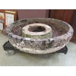 A large composite stone garden basin with decorative banding on sockel